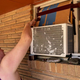 A Washington State resident arranges cardboard above an air conditioning unit during soaring temperatures on July 28, 2022.
